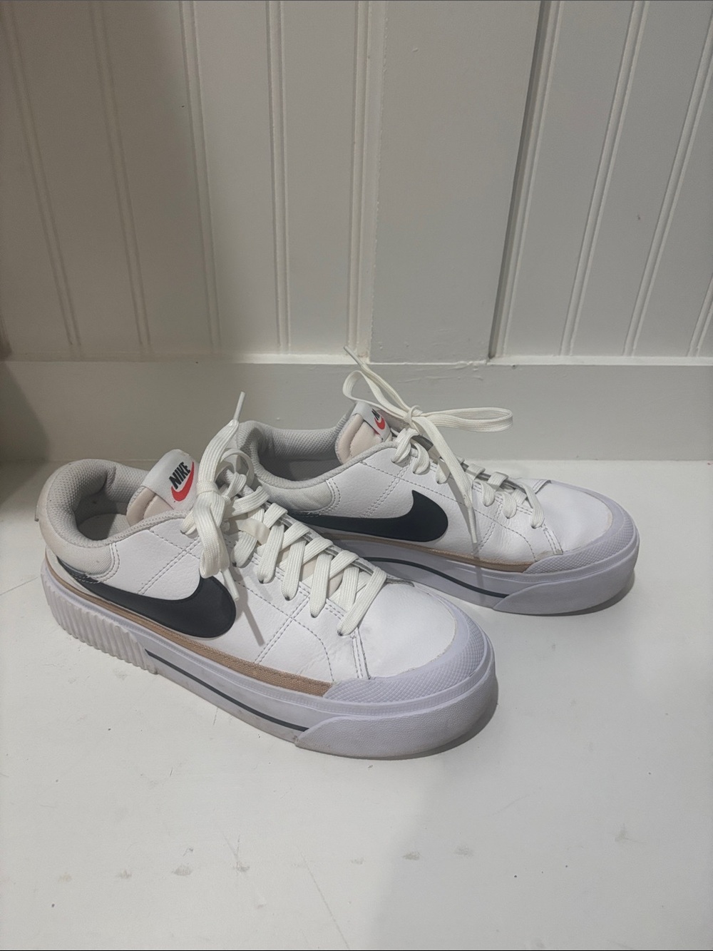 Nike White Sneakers with Black Swoosh and Tan Stripe